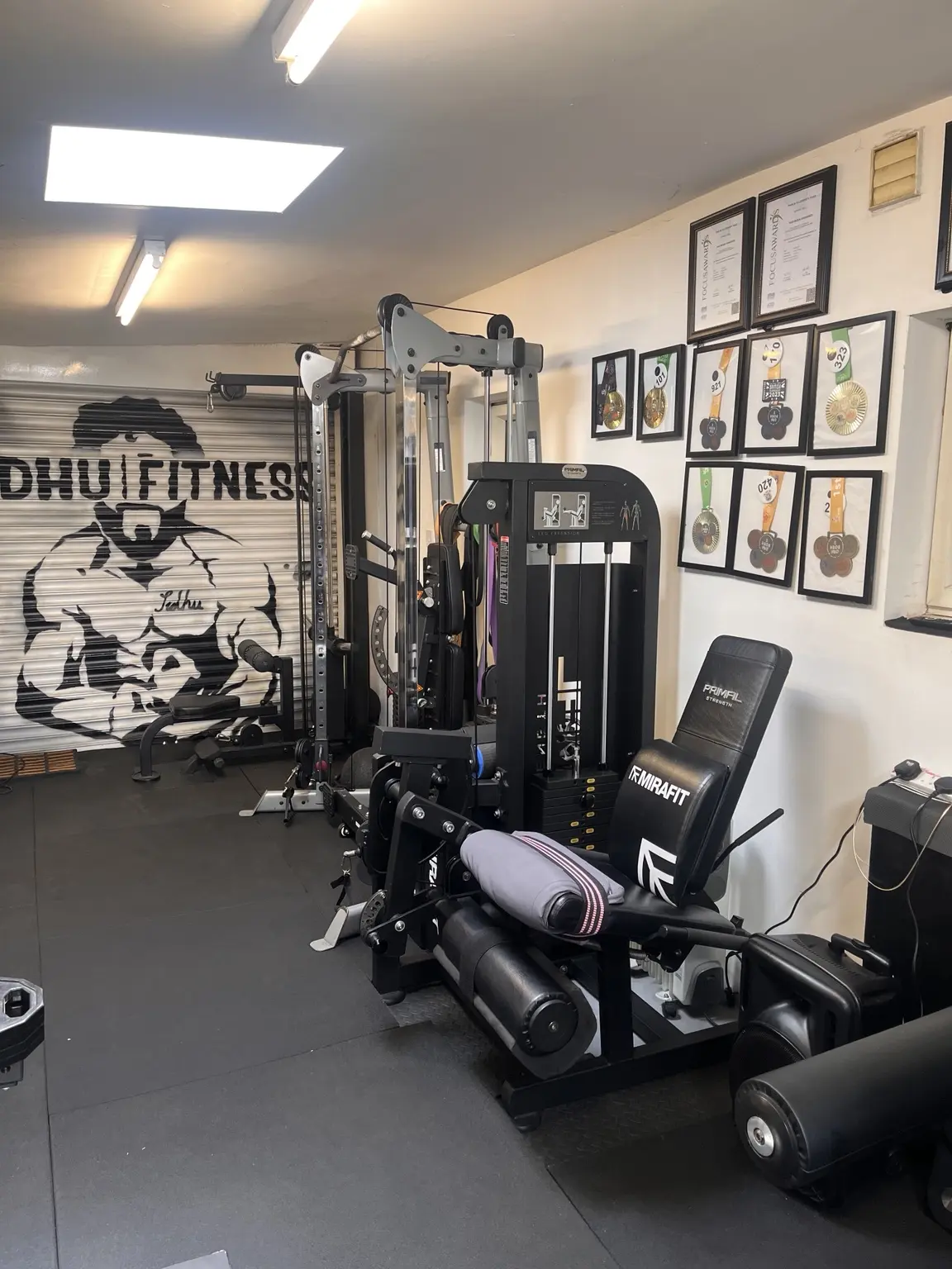 Private Sidhu Fitness studio showing resistance machines, wall branding and training space