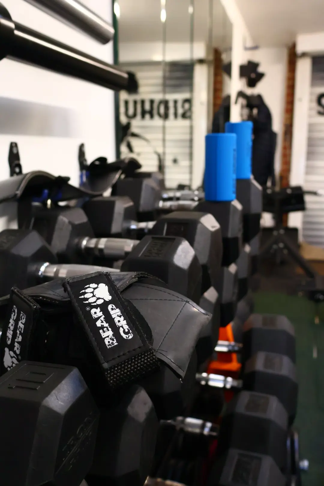 Close-up of the dumbbell training area inside Sidhu Fitness near Heathrow