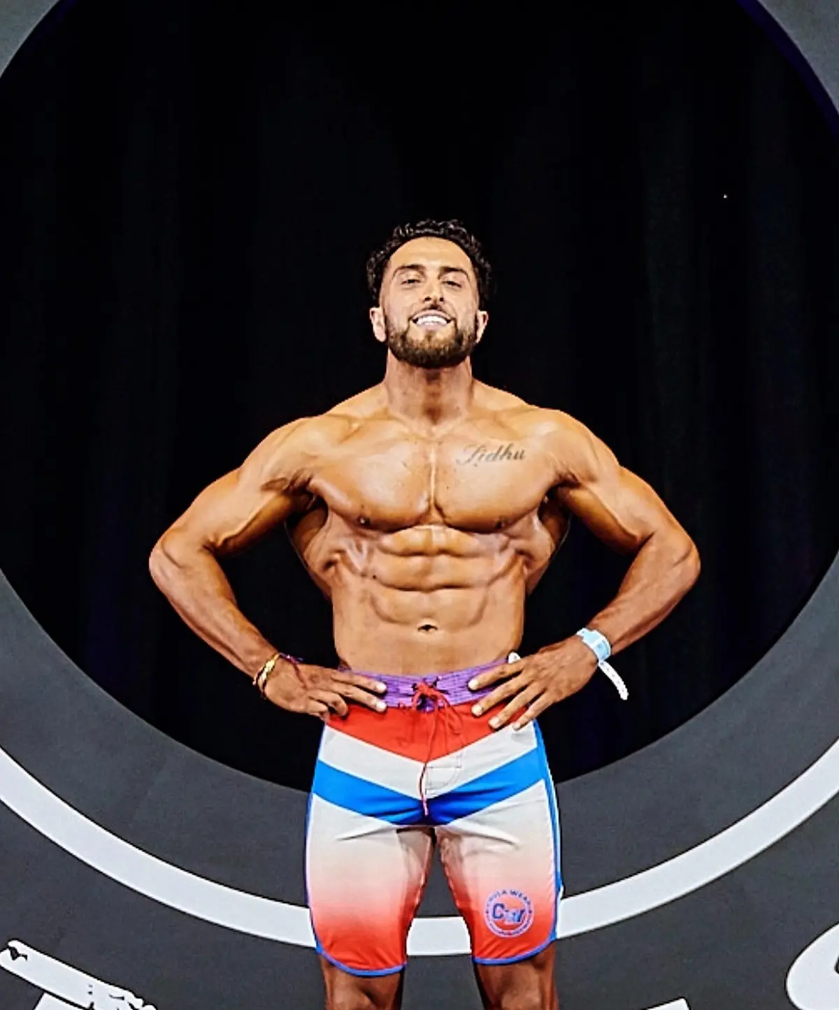 Competitive bodybuilder and Sidhu Fitness founder Tony Sidhu posing on stage